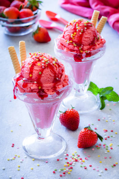 istock Strawberry ice cream sundaecups shot on garden table 946097932