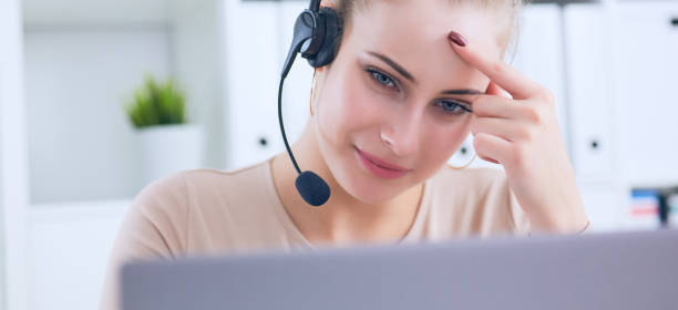 istock Service desk consultant talking on hands-free phone 946102676