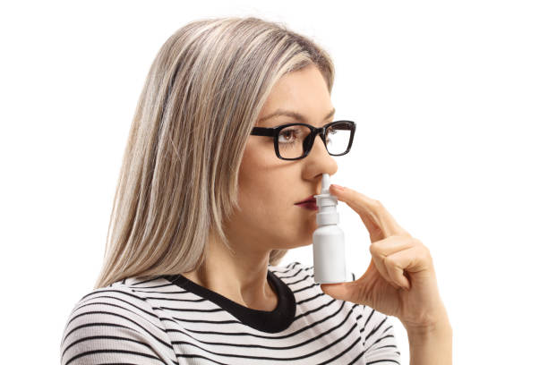 istock Young woman using a nose spray 946106180