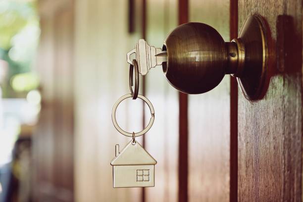istock House key in wooden front door 946110270