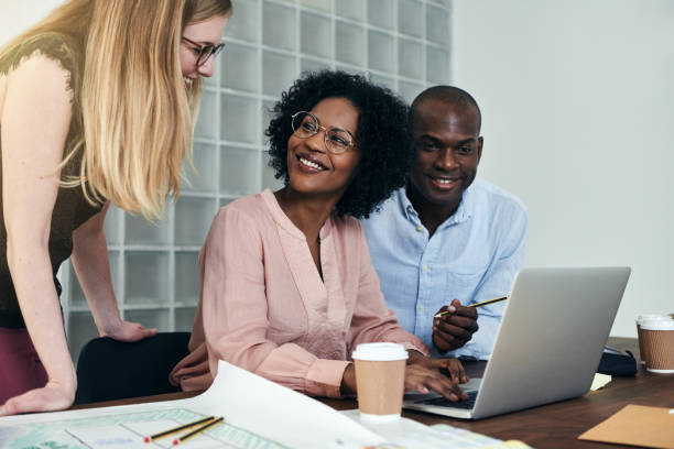 istock Diverse group of smiling colleagues working together in an office 946110878
