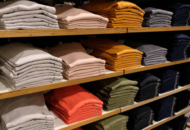 istock Rows of folded colorful clothes in a shop 946118968