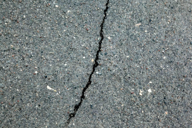 istock A dark crack on the background of a rocky surface. 946137020