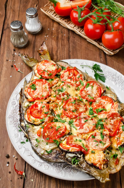 istock Grilled fish with vegetables and cheese 946138802