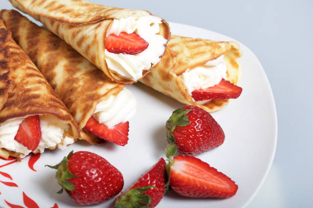 istock Waffle horns with cream, decorated with strawberries. 946139198