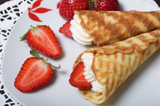istock Waffle horns with cream, decorated with strawberries. 946139224