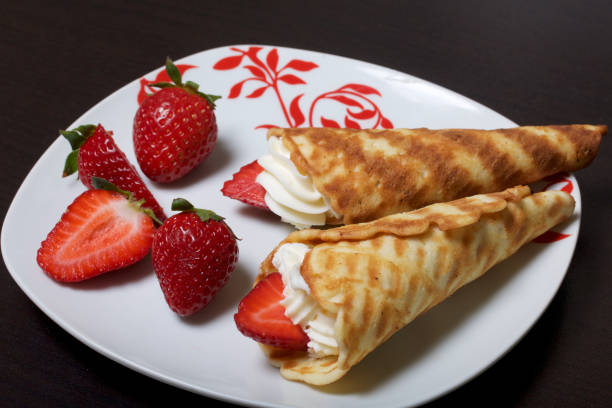 istock Waffle horns with cream, decorated with strawberries. 946139308