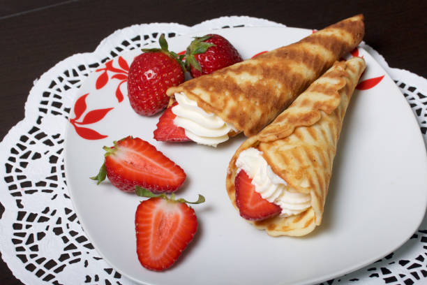 istock Waffle horns with cream, decorated with strawberries. 946139522