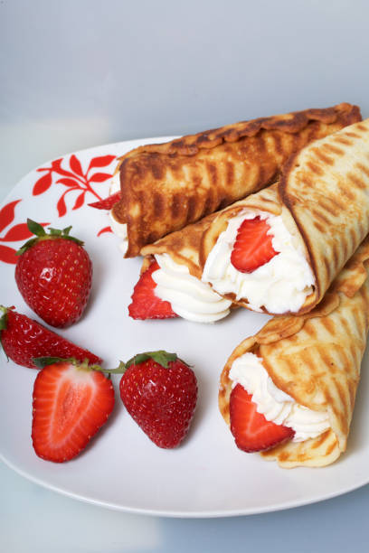 istock Waffle horns with cream, decorated with strawberries. 946139616
