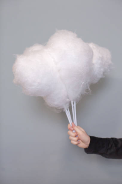 istock Hand holding a bouquet of white cotton candy 946144748