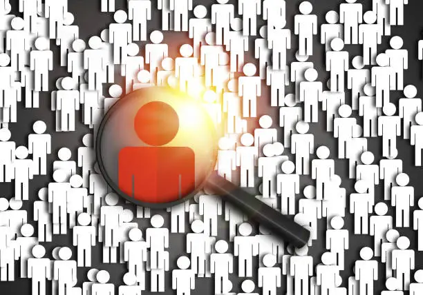 Photo of Searching for the best job candidate and people finder concept looking for the right person to stand out from the crowd.  Top pick and best choice for fitting the skillset that HR is looking for.