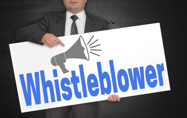 istock Whistleblower poster is held by businessman 946156016