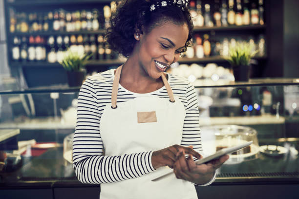 istock Young African cafe owner working with a digital tablet 946156042