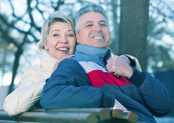 istock Smiling mature couple relaxing in park 946165246