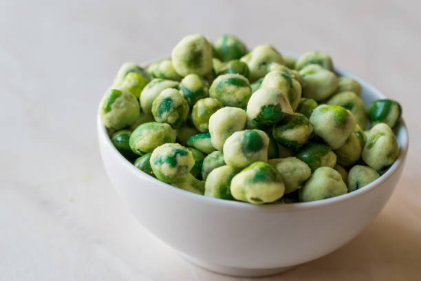 istock Crispy Dry Spiced Green Wasabi Peas as an Appetizer. 946165578