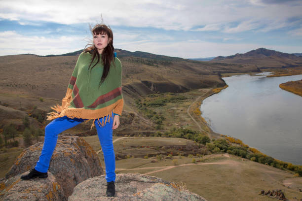 istock Woman on a rock in the mountains 946169404