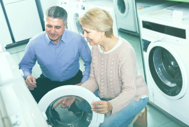 istock Mature couple are choosing home washing machine 946170816