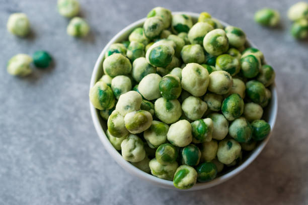 istock Crispy Dry Spiced Green Wasabi Peas as an Appetizer. 946176012