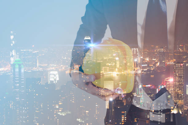 istock Double exposure concept of engineer with safety yellow helmet for workers security with modern city night background. industry concept. 946182932