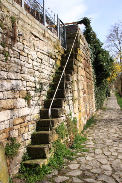 istock stairs in a high wall 946204948