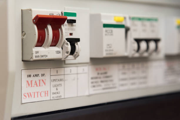 UK domestic electrical consumer unit or fuse box Close up of a MCB (Micro Circuit Breaker) on a UK domestic electrical consumer unit or fuse box amplifier plug stock pictures, royalty-free photos & images