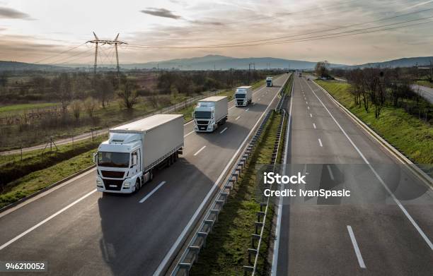 Caravan Or Convoy Of Trucks On Highway Stock Photo - Download Image Now - Truck, Transportation, Freight Transportation