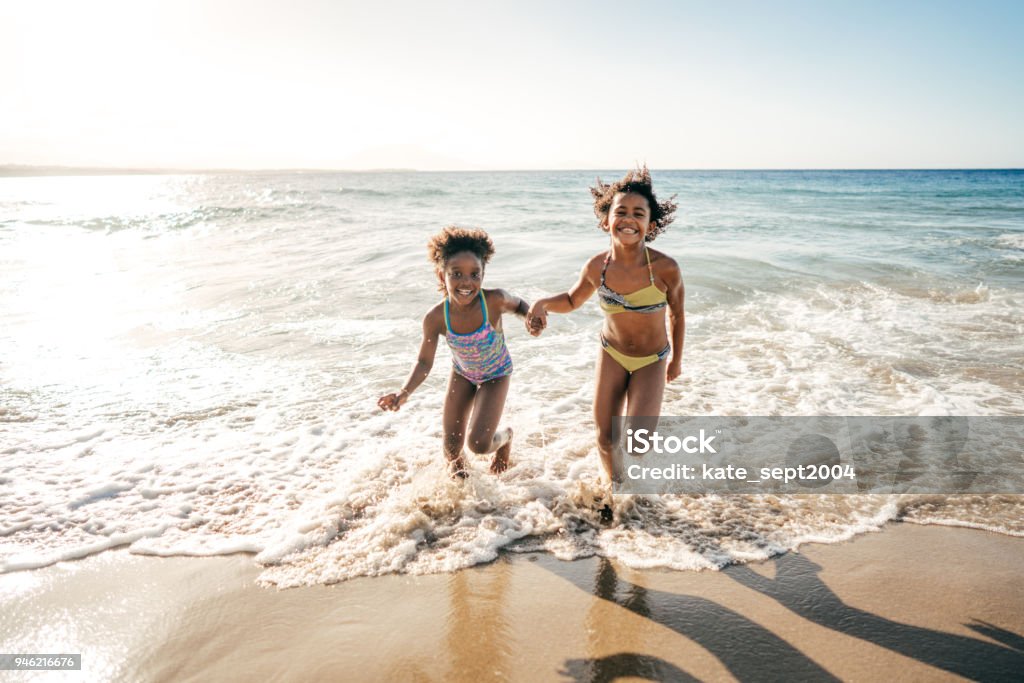 Summer fun Happy girls on the beach Beach Stock Photo