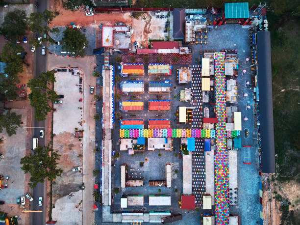 Aerial view at dawn sunset from drone bird eye eagle Angkor container night market in Siem-REap, Cambodia party with coloufull umbrellas and a lot opf textures