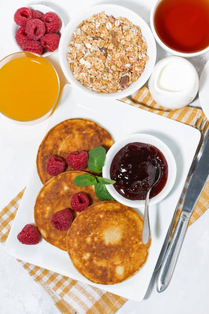 istock delicious pancakes with raspberries and jam for breakfast 946223116