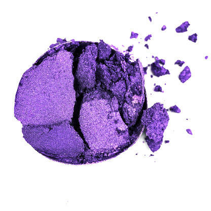 Crushed purple eyeshadow on a white background.