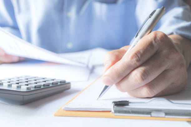 istock Men are Saint documents about accounting with calculator notbook on desk. 946224840