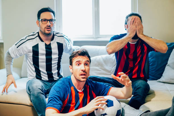 istock Football supporters watching the game from home 946224960