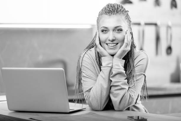 istock Young smiling woman sitting next to computer 946225282