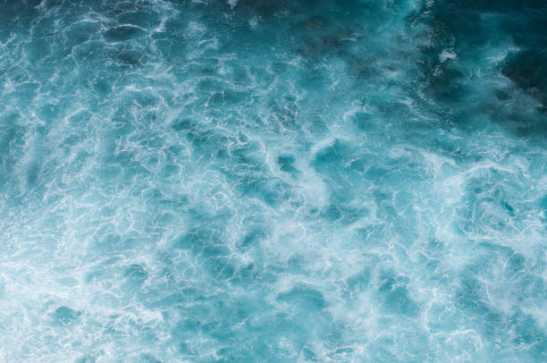 istock Blue deep sea foaming water background 946227860
