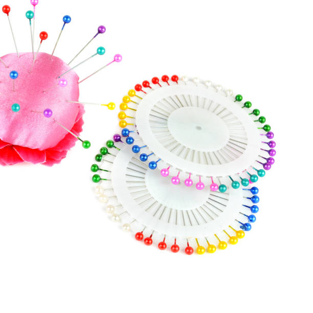 istock Pillow for needles and bright colored pins isolated on white background. 946229968