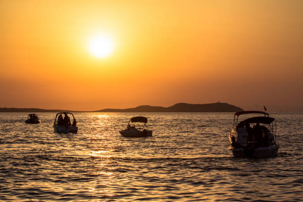 istock Sunset over sea with boats 946233136
