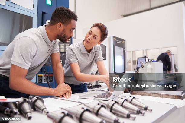 Two Engineers Using Cad Programming Software On Laptop Stock Photo - Download Image Now