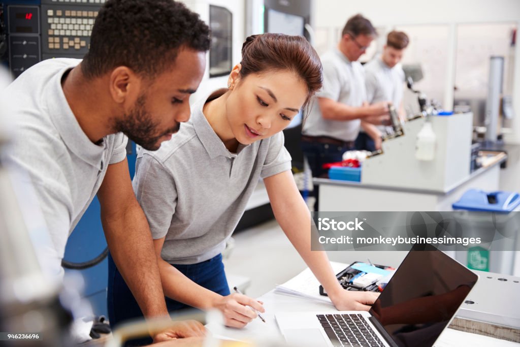 Two Engineers Using Cad Programming Software On Laptop Stock Photo ...