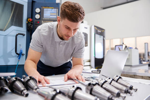 istock Male Engineer Measuring CAD Drawings In Factory 946236732