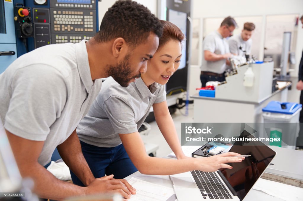 Two Engineers Using Cad Programming Software On Laptop Stock Photo ...