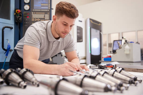 istock Male Engineer Measuring CAD Drawings In Factory 946236842