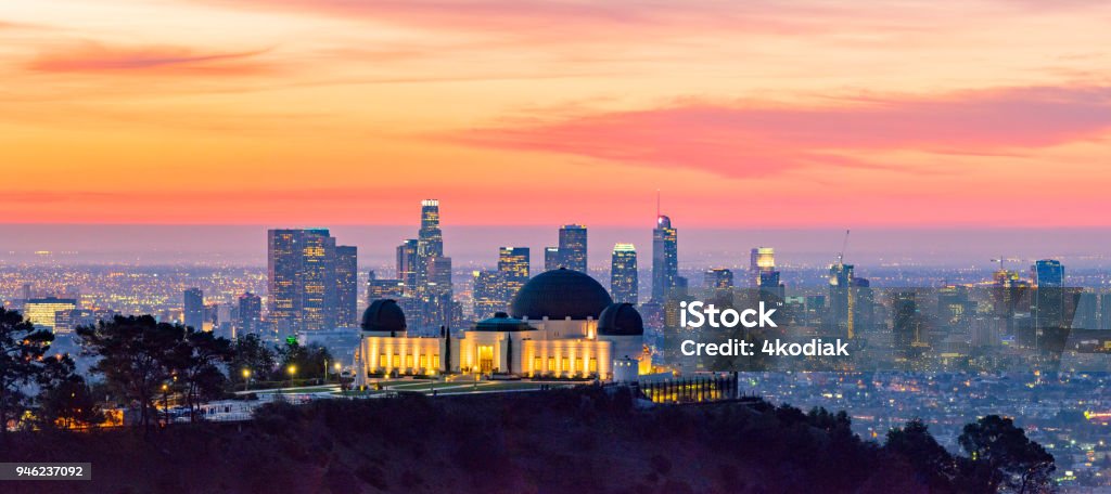 Los Angeles Skyline at Dawn Panorama and Griffith Park Observatory in the Foreground Los Angeles skyline at dawn with Griffith Park Observatory in the foreground City Of Los Angeles Stock Photo