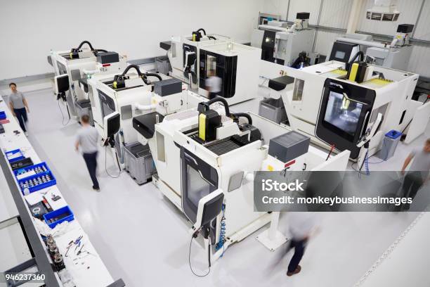 Overhead View Of Engineering Workshop With Workers Using Cnc Machinery Stock Photo - Download Image Now
