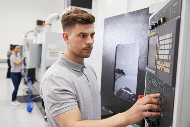 istock Male Engineer Operating CNC Machinery In Factory 946237486