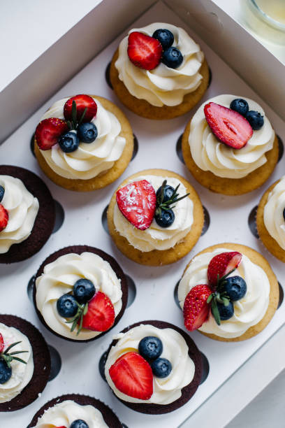 istock cupcakes with cream and berries 946243306