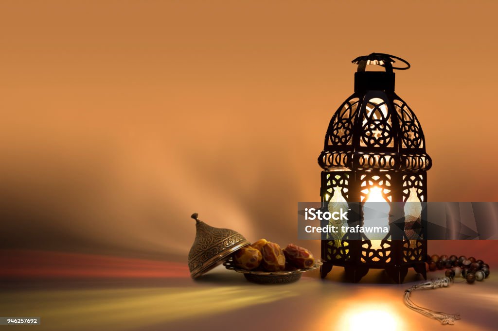 Lantern, prayer beads beads and date fruits with color reflection on background This kind of photos used as greeting cards for ramadan month and eid, also as a background for some holy book words Ramadan Stock Photo