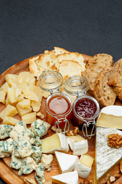 istock Brie cheese on a wooden Board with bread and sweet jam 946263990