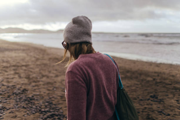 istock Young woman walking by the seaside 946264376