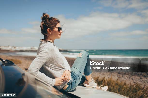 Young Woman Enjoys Seaside View Stock Photo - Download Image Now - Car, Sitting, Smiling