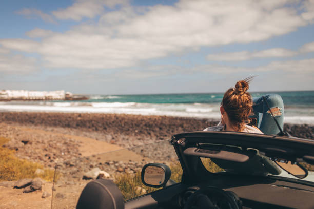 istock Young woman enjoys seaside view 946269650